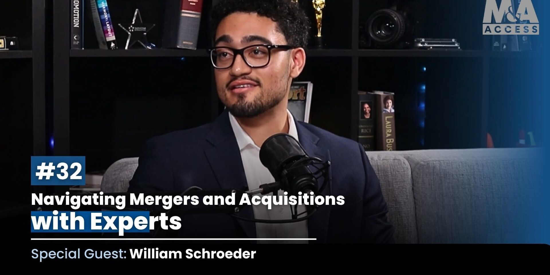Host wearing glasses and a navy suit speaks into a microphone on a podcast set, with a bookshelf backdrop and title text reading "#32 Navigating Mergers and Acquisitions with Experts; Special Guest: William Schroeder".