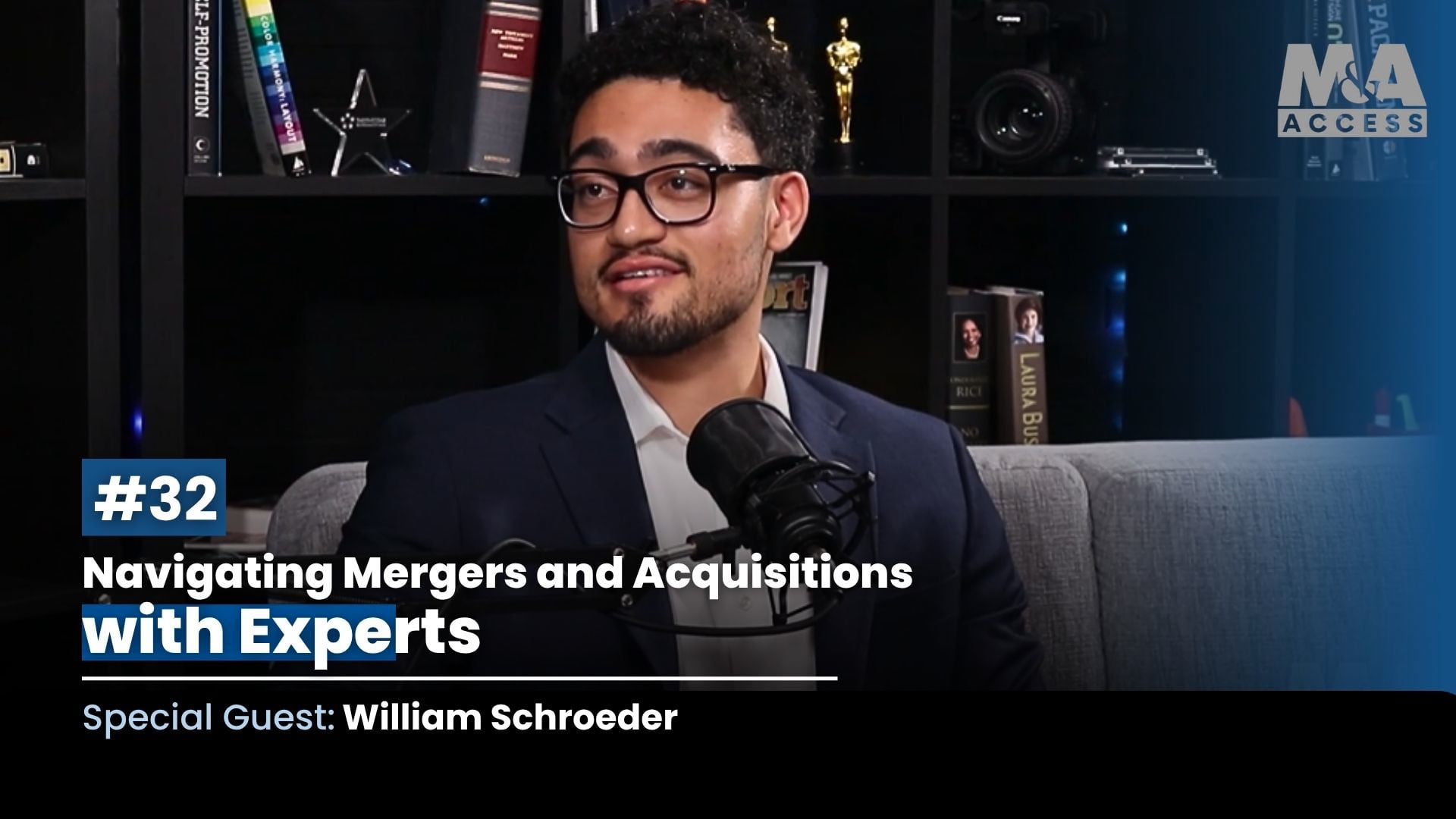 Host wearing glasses and a navy suit speaks into a microphone on a podcast set, with a bookshelf backdrop and title text reading "#32 Navigating Mergers and Acquisitions with Experts; Special Guest: William Schroeder".